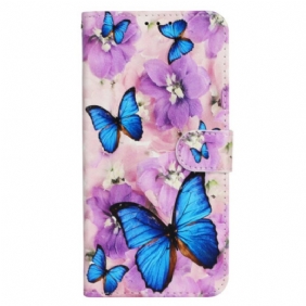 Folio-hoesje iPhone 16 Pro Telefoonhoesje Blauwe Vlinders En Paarse Bloemen Met Riempje